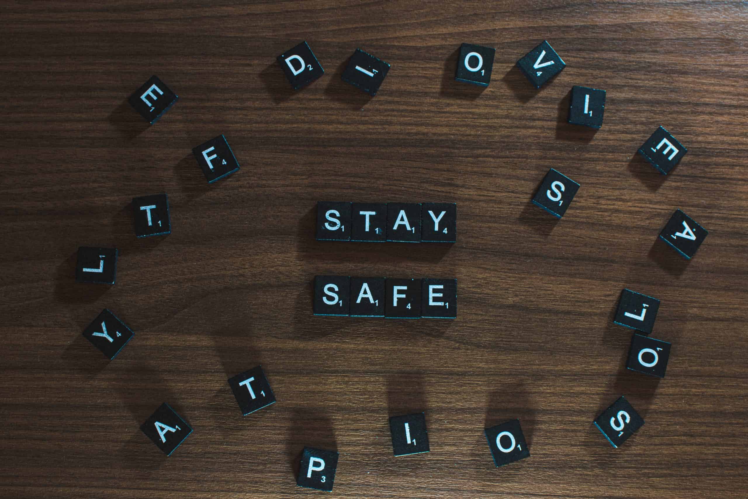 Stay safe spelled out in scrabble pieces on a desk